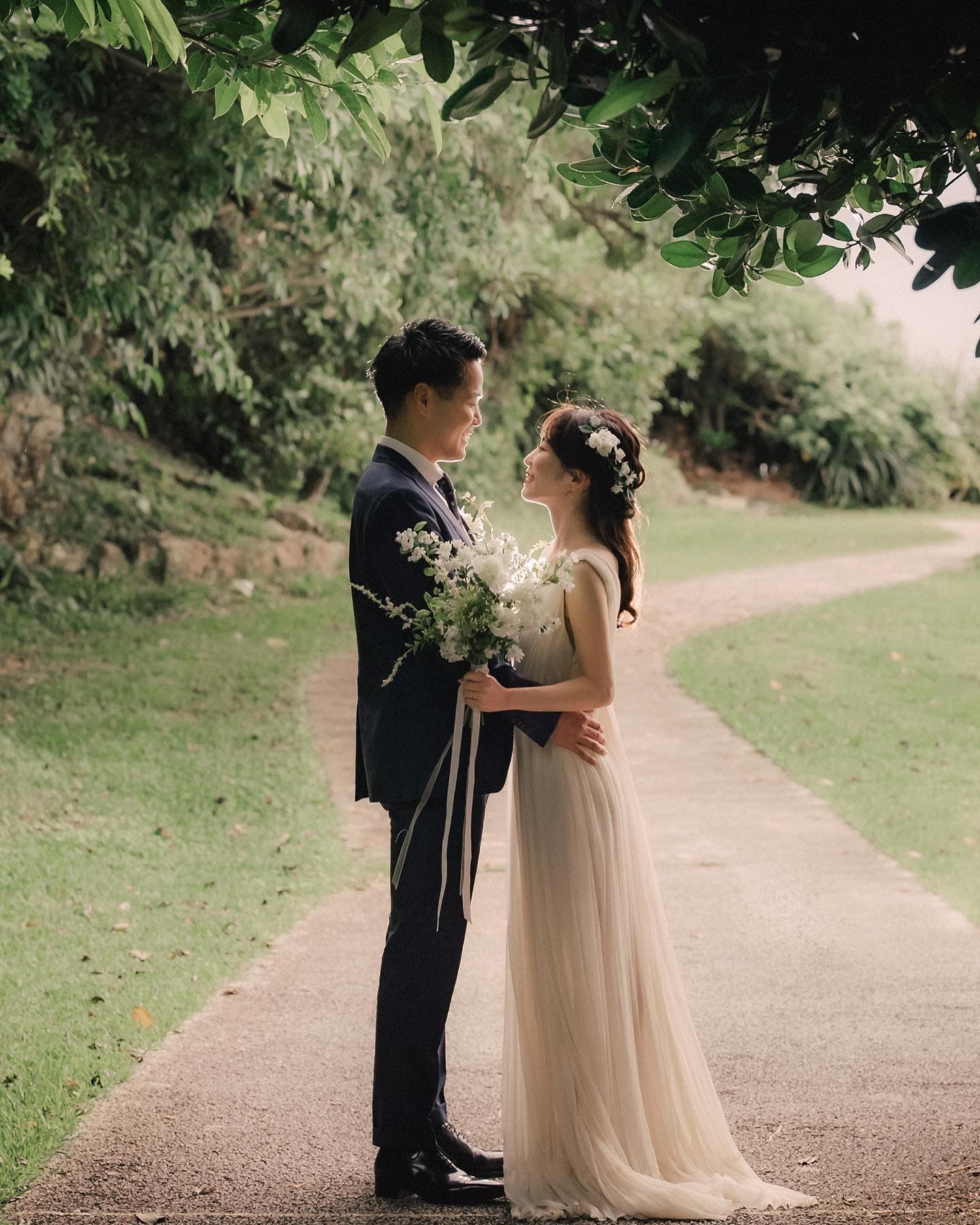 Couple facing each other on a quiet tree-lined path on an overcast day