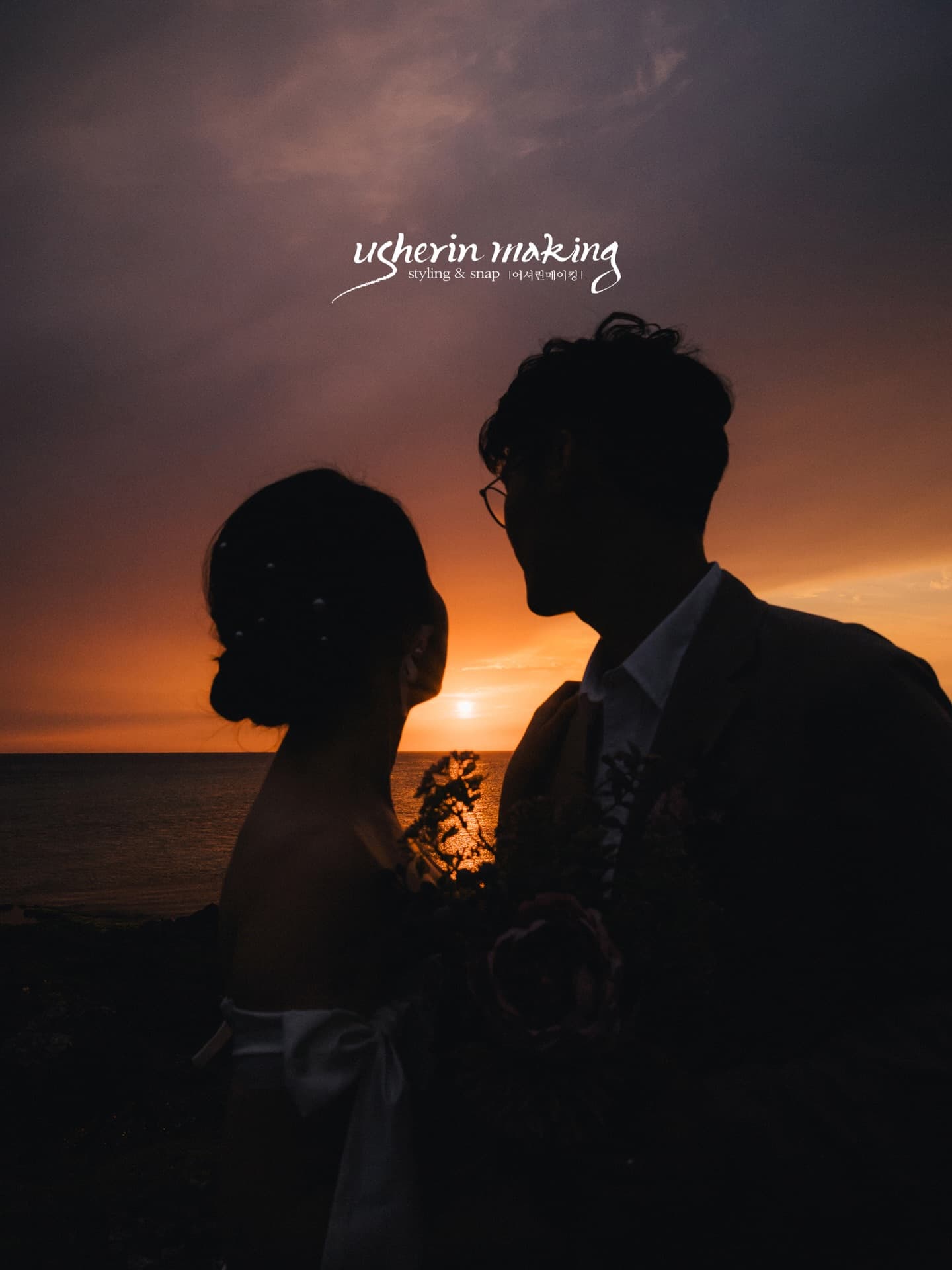 Silhouetted couple facing each other against a fiery orange sunset over the Okinawa sea