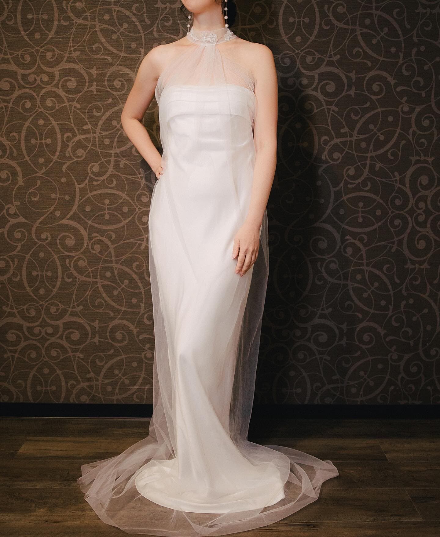 Full-length look with a sheer halter-neck tulle bolero over a straight column dress