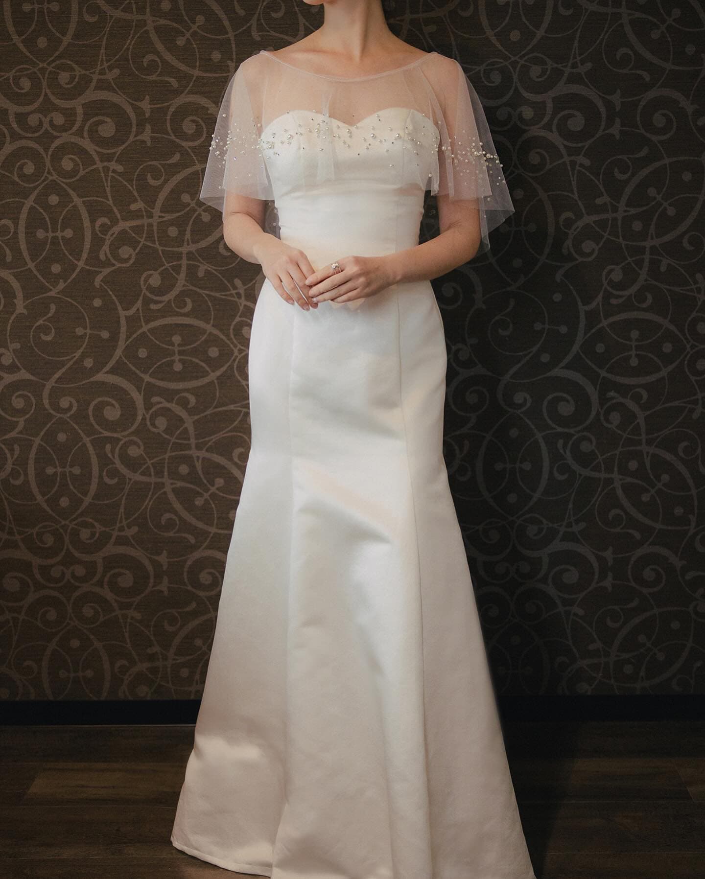 Front view of the sweetheart bodice under the sheer pearl capelet