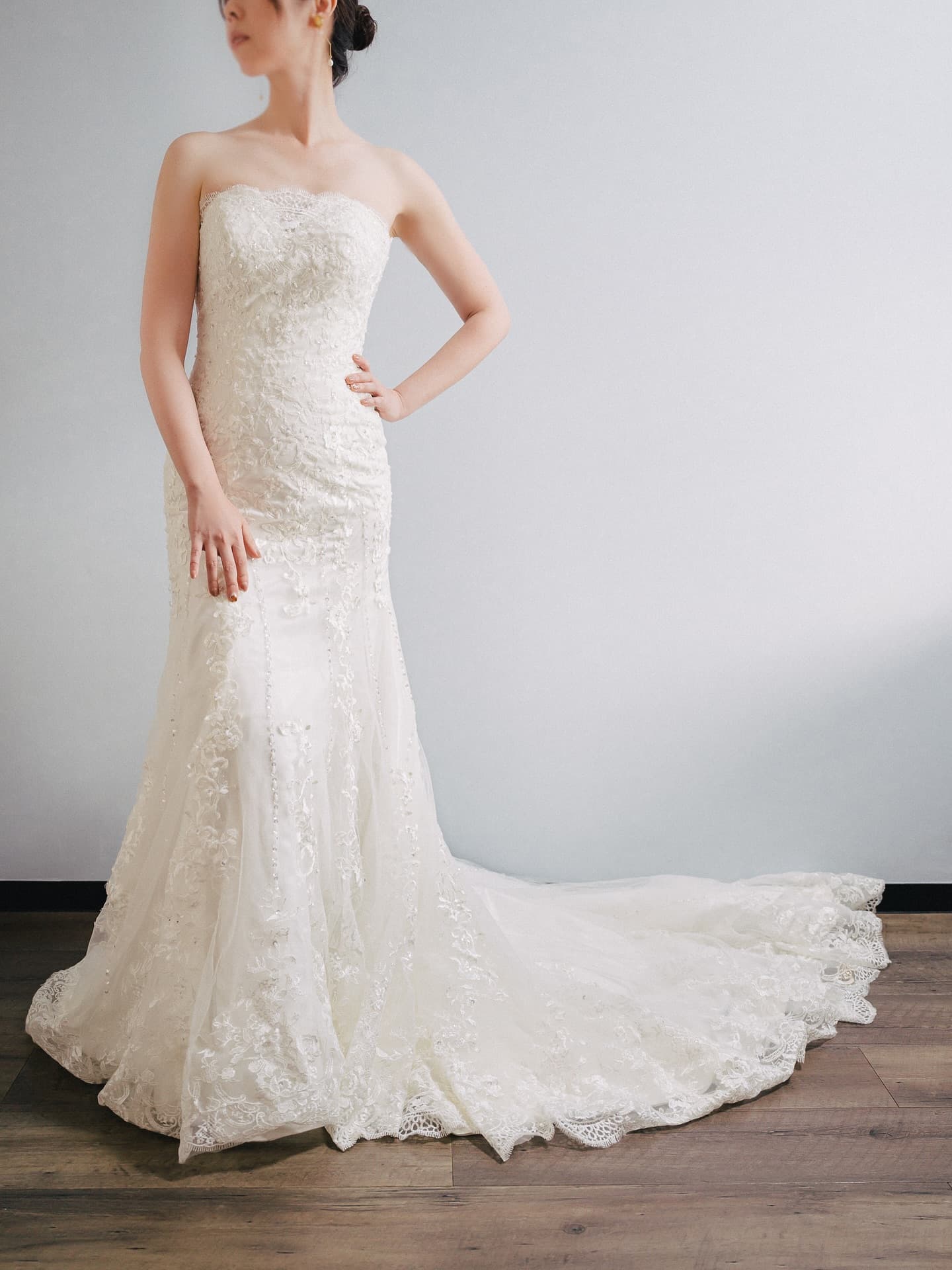 Strapless all-lace mermaid gown with its train spread out, front view