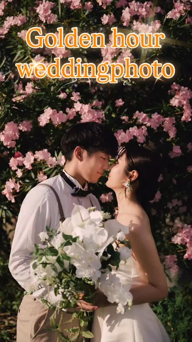 Couple almost kissing among pink blossoms at golden hour in Okinawa