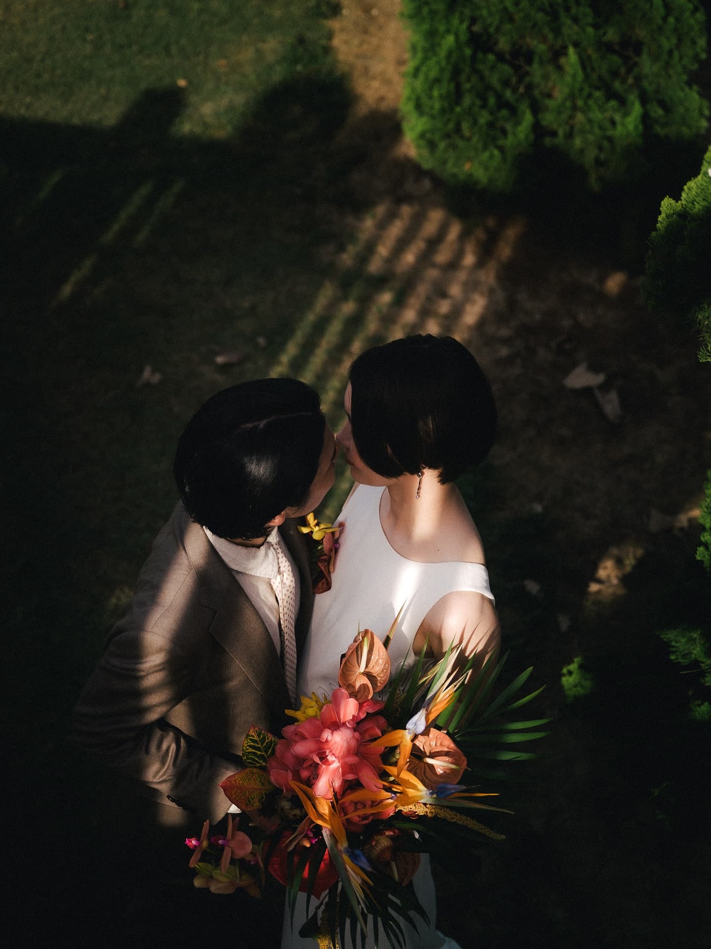 Overhead view of a couple kissing in golden light in Okinawa