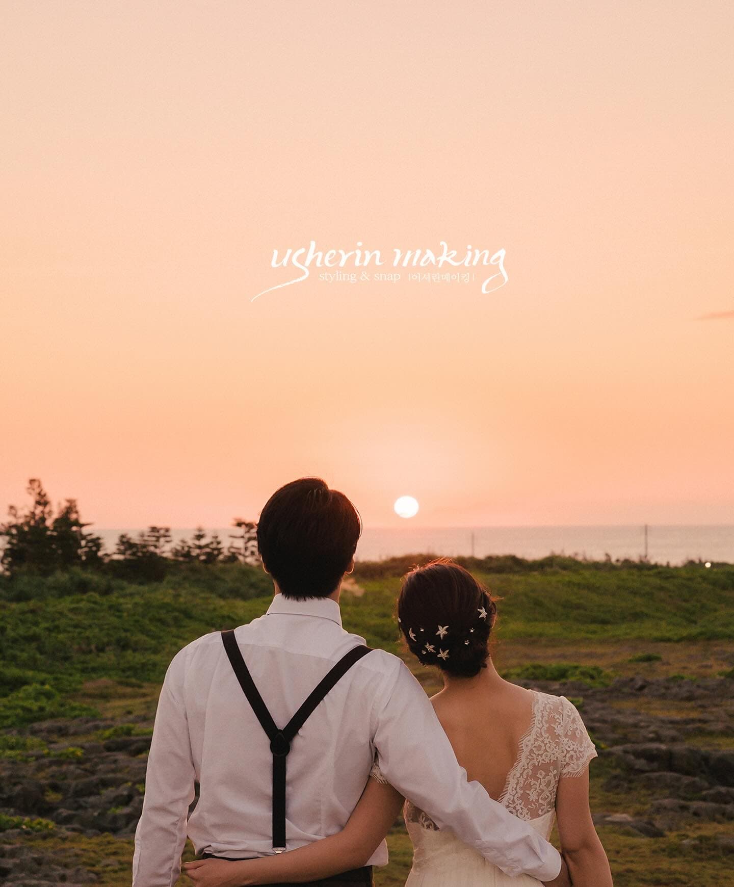 Back view of a couple arm in arm watching the sun set over the sea in Okinawa