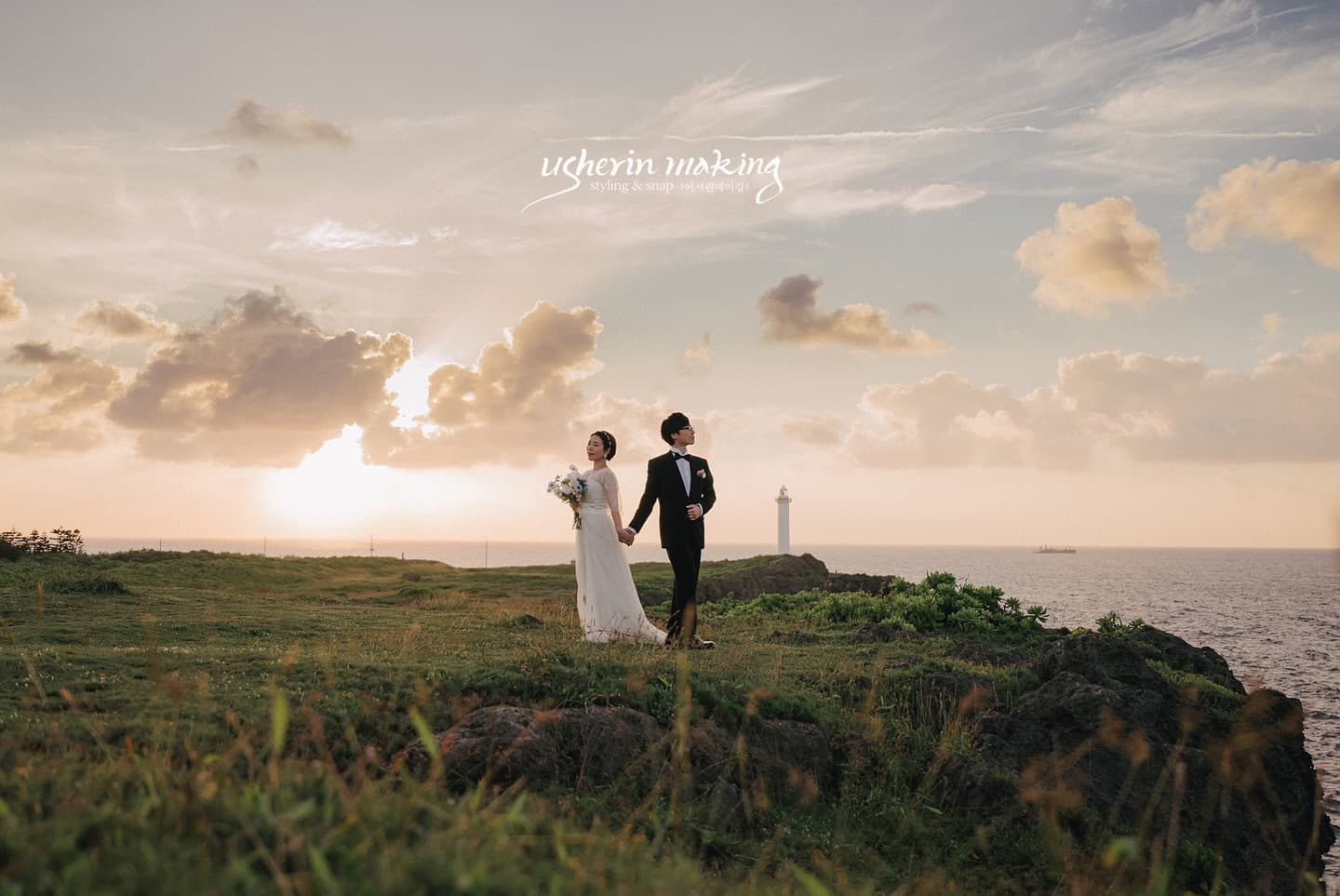 Couple holding hands on a sunset cape overlooking an Okinawa lighthouse