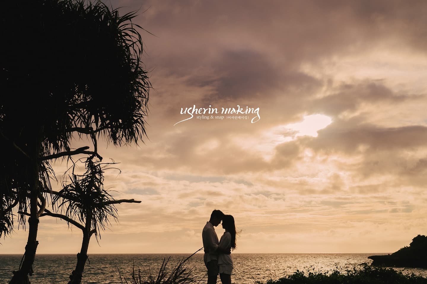 Silhouetted couple facing each other on an Okinawa beach at dramatic dusk
