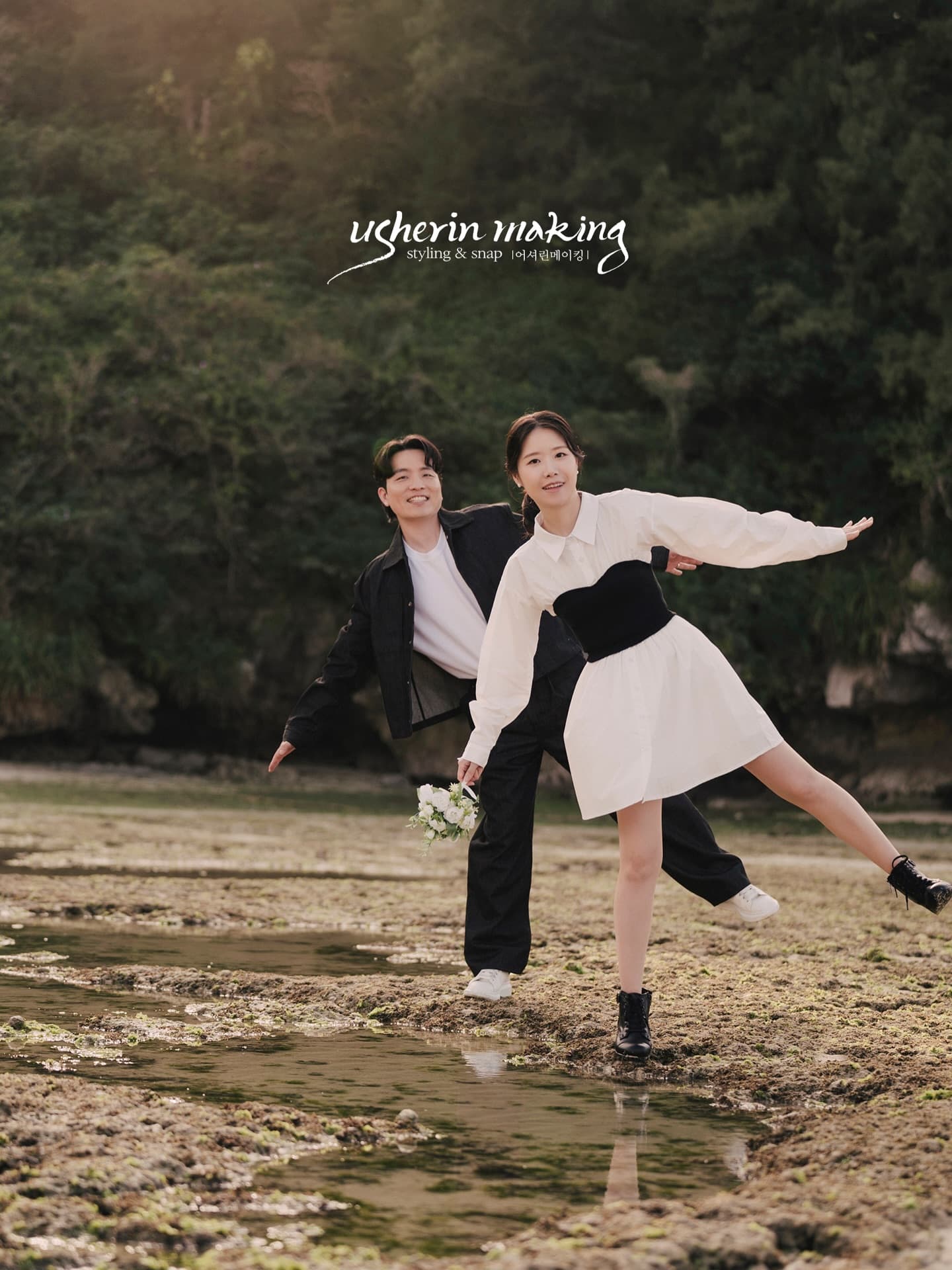 Playful couple posing on rocky tide flats by the sea in Okinawa
