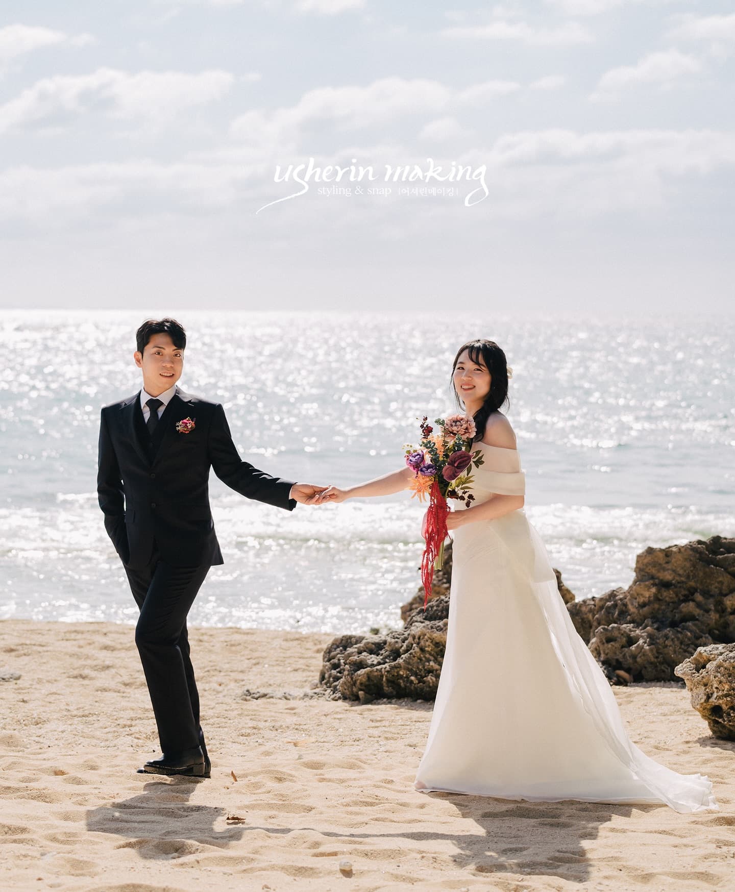 Bride and groom walking hand in hand on a sunlit beach, Okinawa